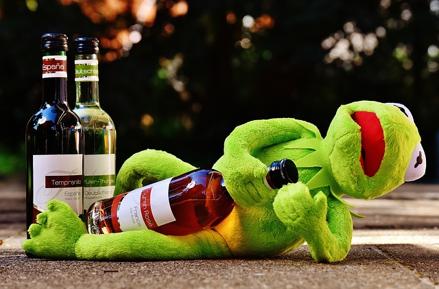 Kermit opens a bottle